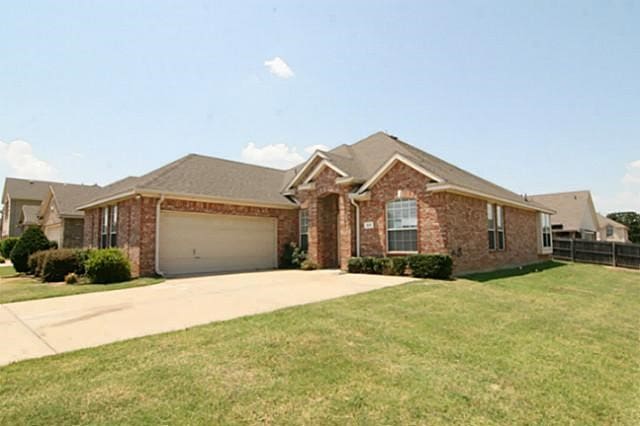 ranch-style house with a front lawn and a garage