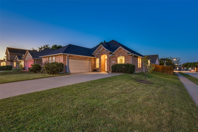 ranch-style home with a yard and a garage