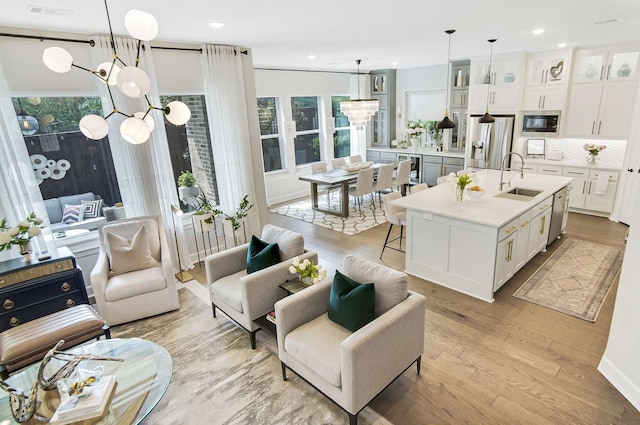 interior space with hanging light fixtures, plenty of natural light, and white cabinetry