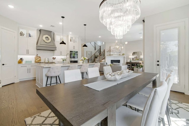 dining space with sink and light hardwood / wood-style flooring