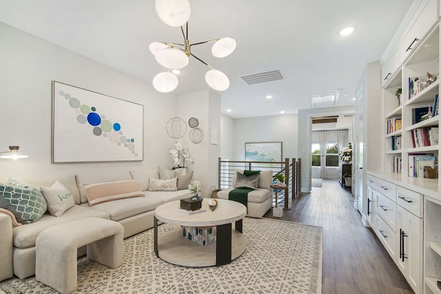 living room with wood-type flooring and a notable chandelier