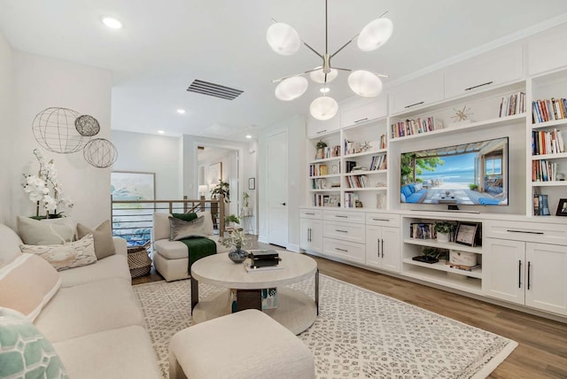 living room featuring wood-type flooring and a chandelier