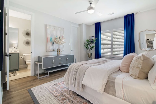 bedroom featuring connected bathroom, ceiling fan, and dark hardwood / wood-style floors