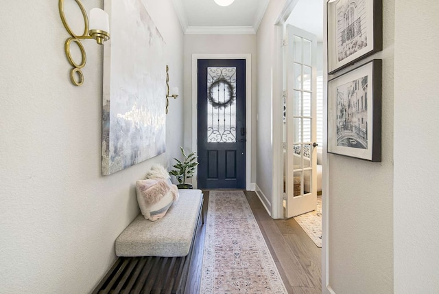 doorway with ornamental molding and dark hardwood / wood-style flooring