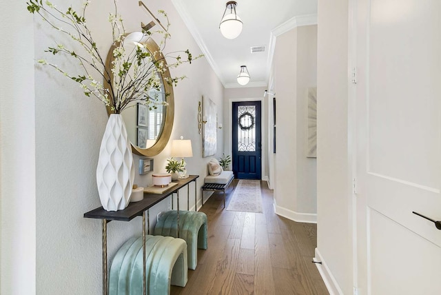 entryway with dark wood-type flooring and crown molding