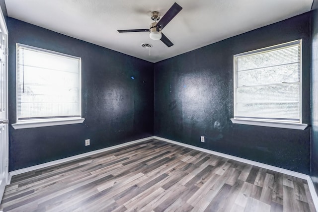 spare room with hardwood / wood-style floors and ceiling fan