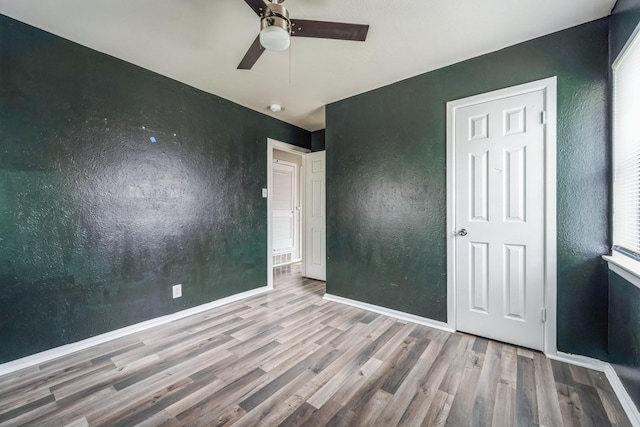 unfurnished bedroom featuring ceiling fan and light hardwood / wood-style floors