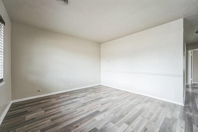 spare room with wood-type flooring