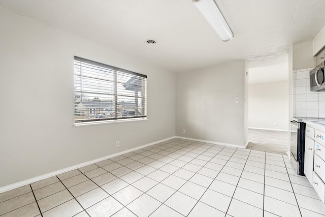 unfurnished living room featuring light tile patterned floors