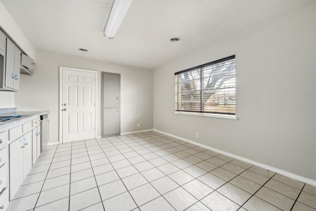 kitchen featuring dishwasher and light tile patterned floors