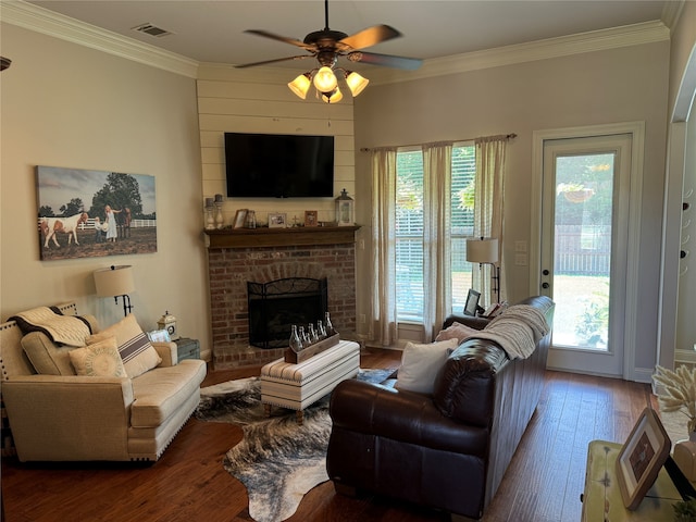 living room with a fireplace, dark hardwood / wood-style floors, ceiling fan, and a wealth of natural light