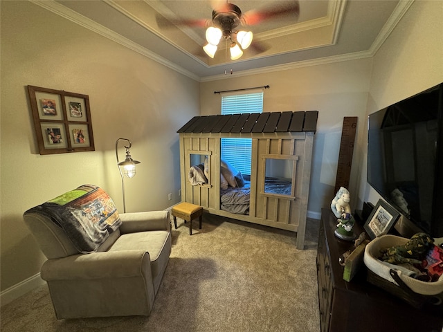 bedroom featuring a raised ceiling, carpet flooring, ornamental molding, and ceiling fan