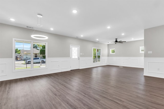 empty room with plenty of natural light and dark hardwood / wood-style floors