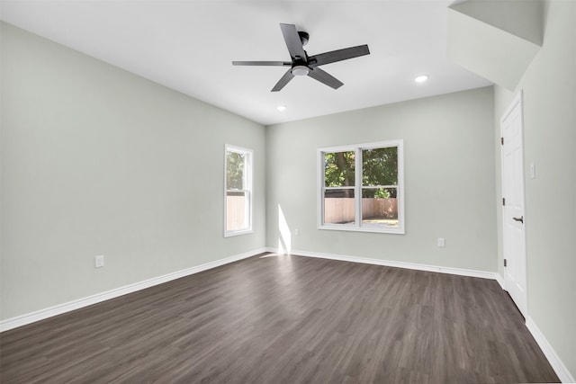 spare room featuring dark wood-type flooring and ceiling fan