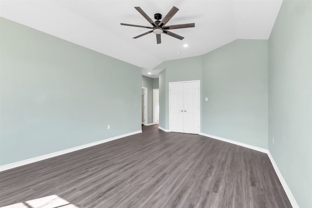 spare room featuring ceiling fan, dark hardwood / wood-style flooring, and lofted ceiling