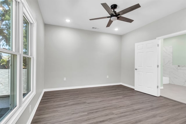 empty room featuring ceiling fan and dark wood-type flooring