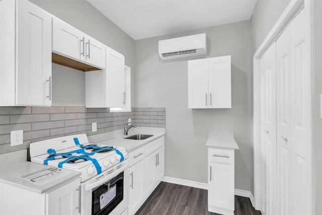 kitchen featuring sink, white cabinets, gas range gas stove, and a wall mounted AC