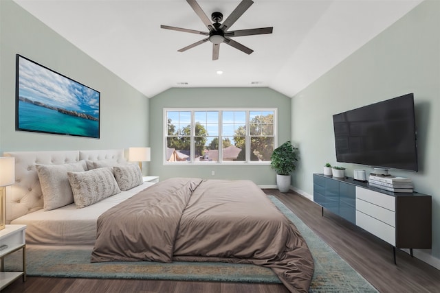 bedroom with ceiling fan, dark hardwood / wood-style flooring, and lofted ceiling