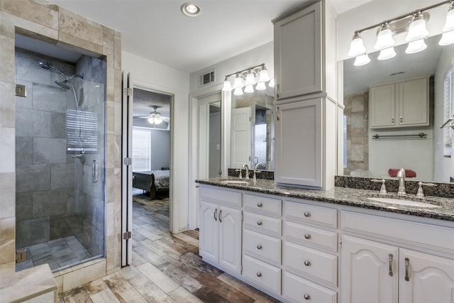 bathroom with vanity, ceiling fan, a shower with door, and hardwood / wood-style floors