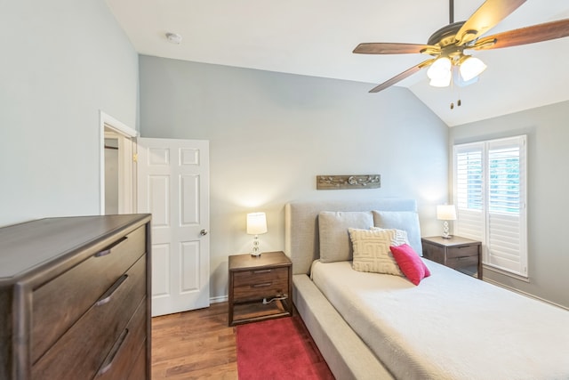 bedroom with vaulted ceiling, hardwood / wood-style floors, and ceiling fan