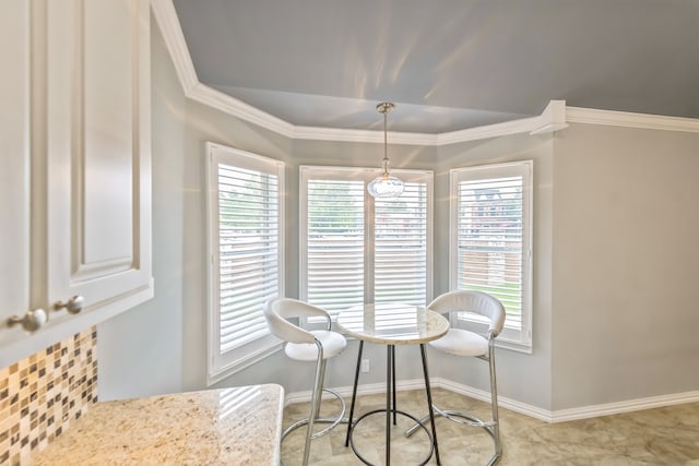 dining room featuring crown molding