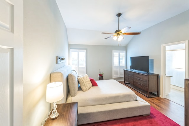 bedroom with lofted ceiling, hardwood / wood-style floors, and ceiling fan