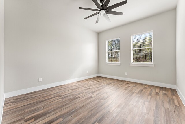 empty room featuring hardwood / wood-style floors and ceiling fan