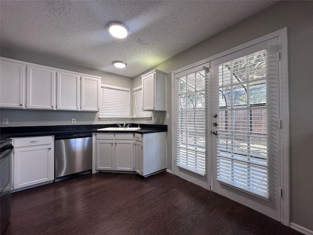 kitchen featuring white cabinets, sink, stainless steel dishwasher, a textured ceiling, and dark hardwood / wood-style flooring