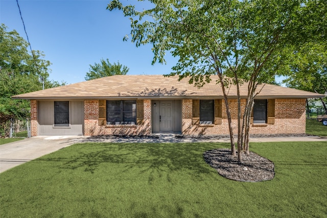 ranch-style house with brick siding and a front lawn