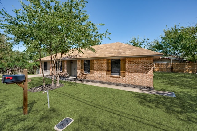 ranch-style house with brick siding, a front yard, and fence