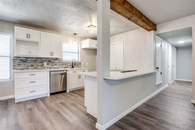 kitchen featuring backsplash, white cabinets, light wood-style floors, and stainless steel dishwasher