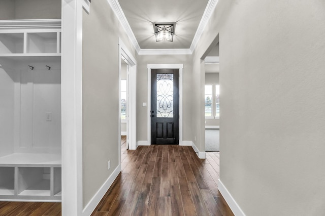 entryway with dark hardwood / wood-style flooring and crown molding