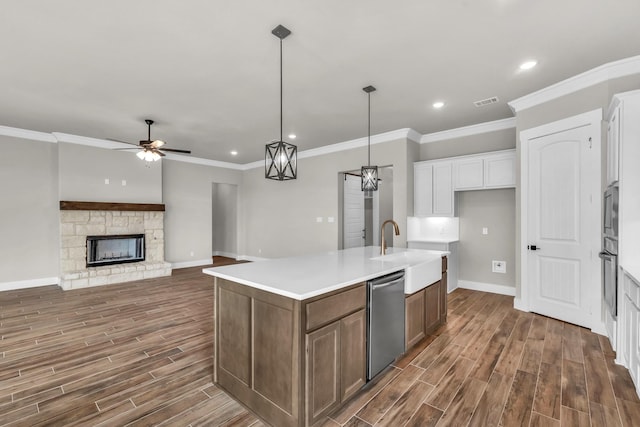 kitchen featuring white cabinetry, a center island with sink, stainless steel appliances, and dark hardwood / wood-style floors