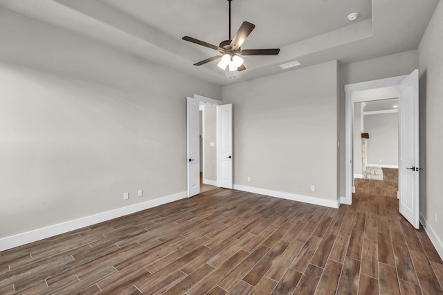 unfurnished bedroom with ceiling fan and dark wood-type flooring