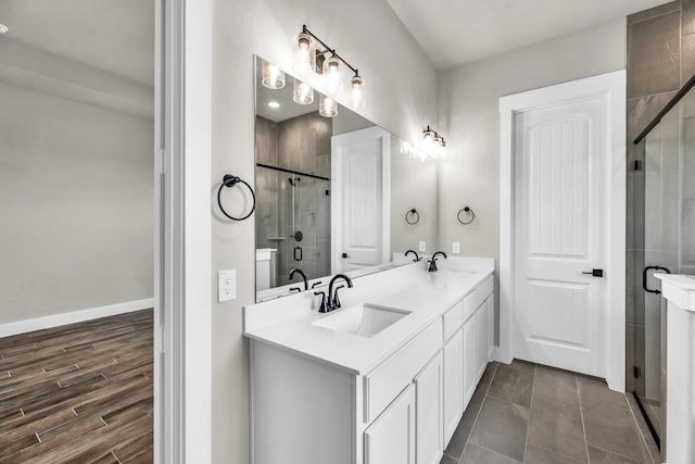 bathroom featuring hardwood / wood-style floors, vanity, and walk in shower