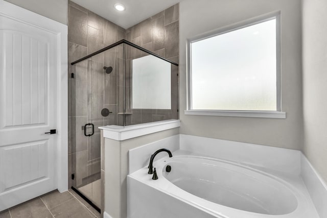 bathroom featuring tile patterned flooring and separate shower and tub