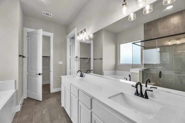 bathroom featuring tile patterned floors, vanity, and independent shower and bath