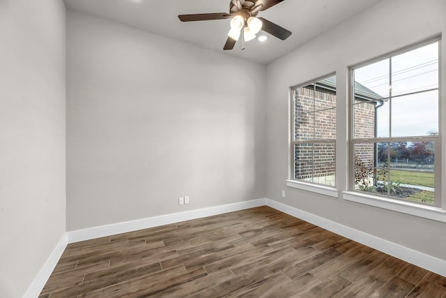 empty room with dark hardwood / wood-style flooring, ceiling fan, and a healthy amount of sunlight