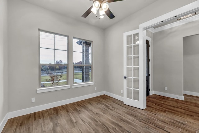 unfurnished room featuring wood-type flooring, french doors, ceiling fan, and ornamental molding