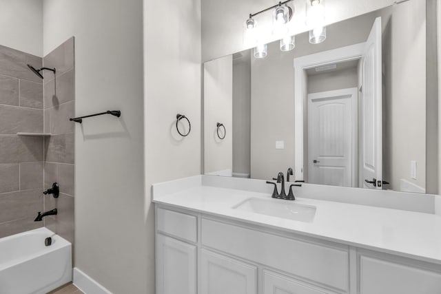 bathroom featuring vanity and tiled shower / bath