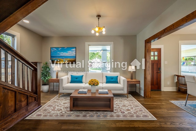 living area featuring dark hardwood / wood-style floors and an inviting chandelier