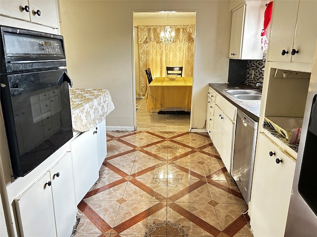 kitchen with sink, white cabinetry, an inviting chandelier, black oven, and stainless steel dishwasher