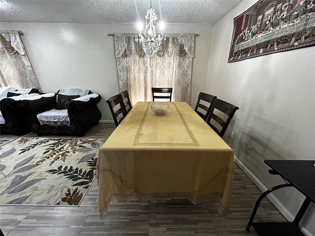 dining area featuring an inviting chandelier, hardwood / wood-style floors, and a textured ceiling