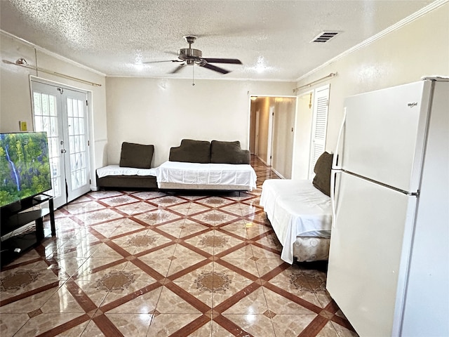 living room featuring a textured ceiling, crown molding, ceiling fan, and french doors