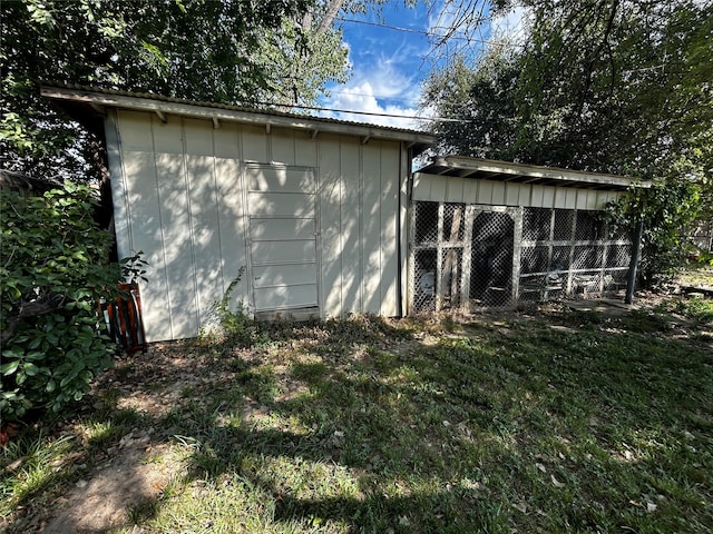 view of outbuilding featuring a yard