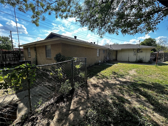 back of property featuring a lawn