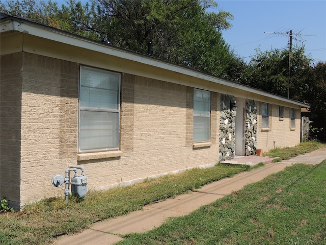 view of property exterior with a yard