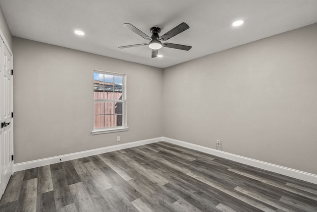 empty room with ceiling fan and dark hardwood / wood-style floors