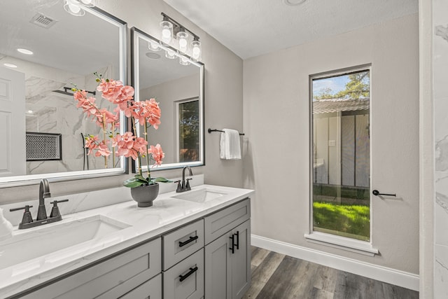 bathroom featuring a textured ceiling, vanity, and hardwood / wood-style floors