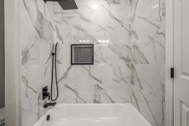 bathroom featuring tiled shower / bath